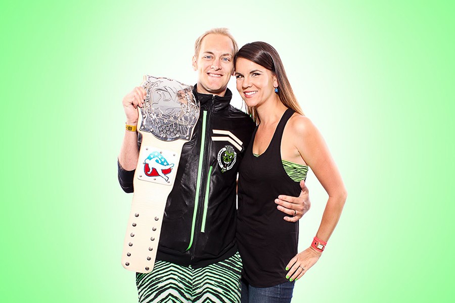 Jason Farnan, the 2013 US National Air Guitar Champion, holds his championship belt with his air guitar coach and wife, Lisa Farnan.