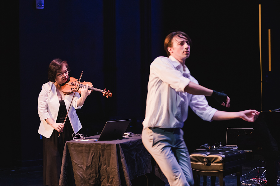 Mari Kimura and dancer Jacob Machmer (M.F.A. ‘19) perform “CetaceAria” during a 2018 performance. Machmer demonstrates the MUGIC® motion sensor product (on his right hand) through a series of motions and improvisational dance