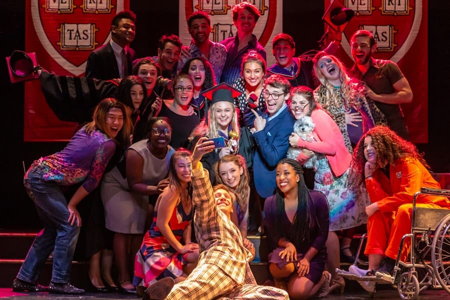 An excited, diverse musical cast celebrates on stage