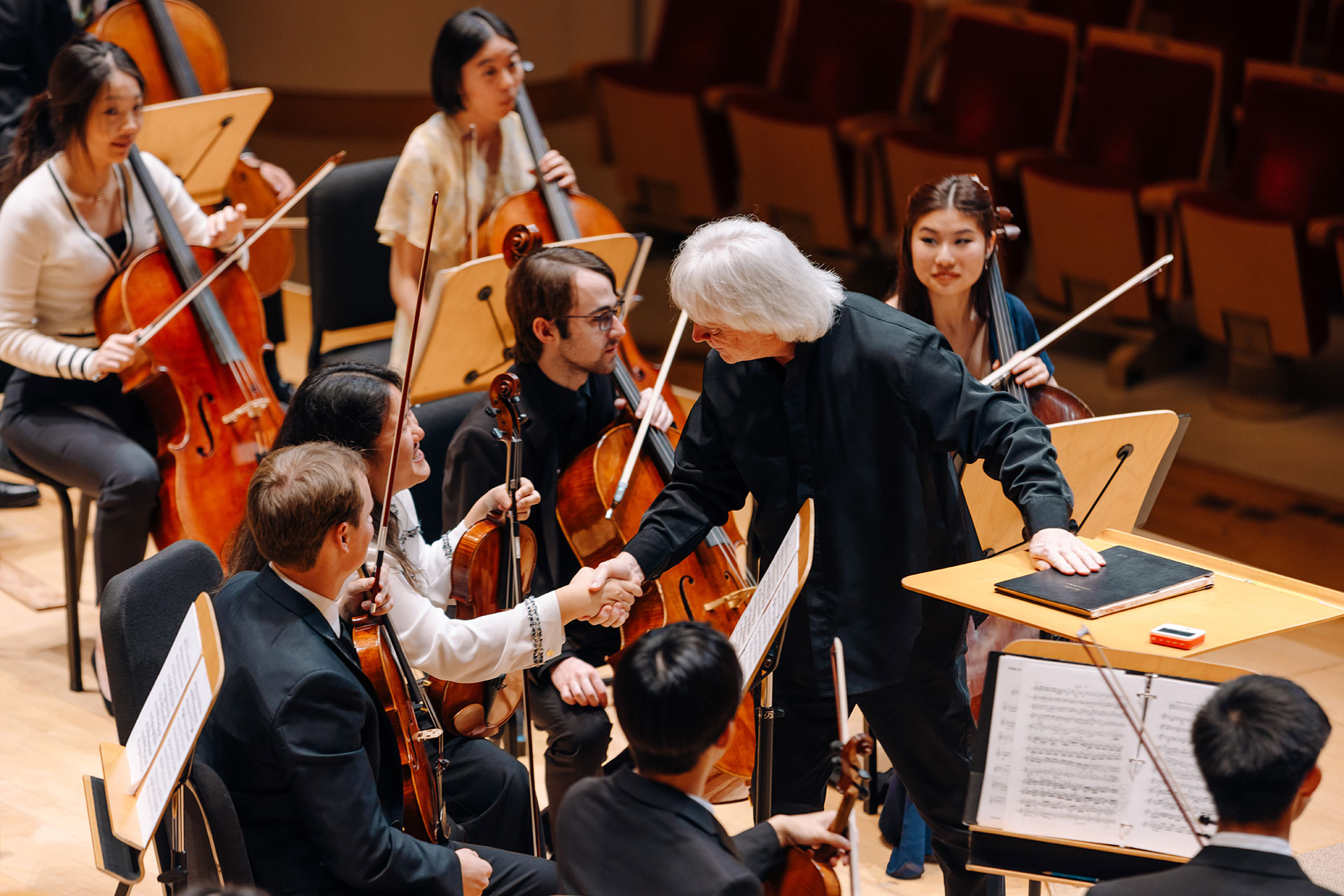Music Director for Pacific Symphony Carl St.Clair greets the students before the masterclass rehearsal at the Renée and Henry Segerstrom Concert Hall.
