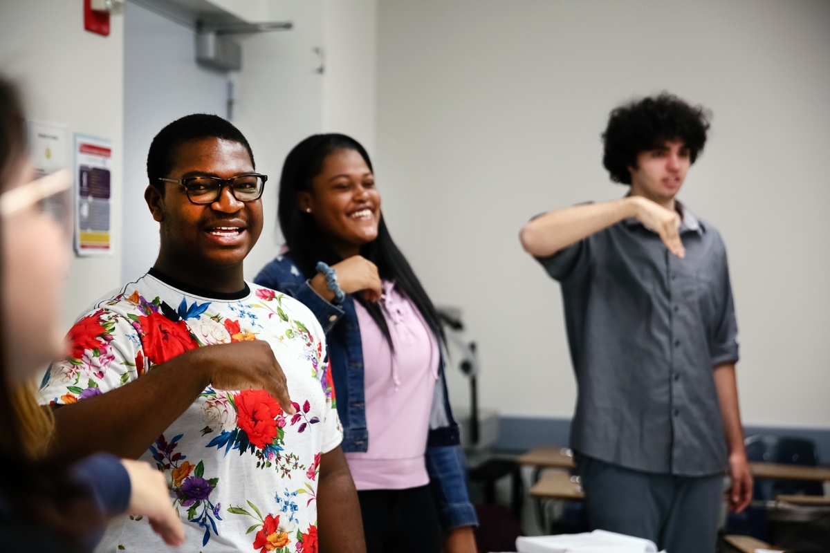 Moses Carter (far left) both performs and bonds with classmates during a music class held in the Music and Media Building.