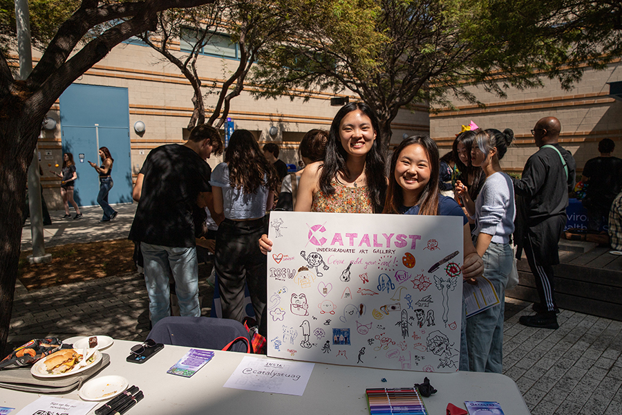 Two girls boothing for Catalyst in the Arts School.