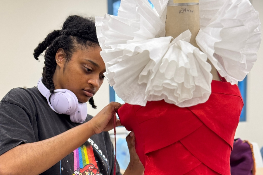 Department of Art alumnus Jayla Aldridge designing for Upcycled Couture. Photo courtesy of Laguna Art Museum.