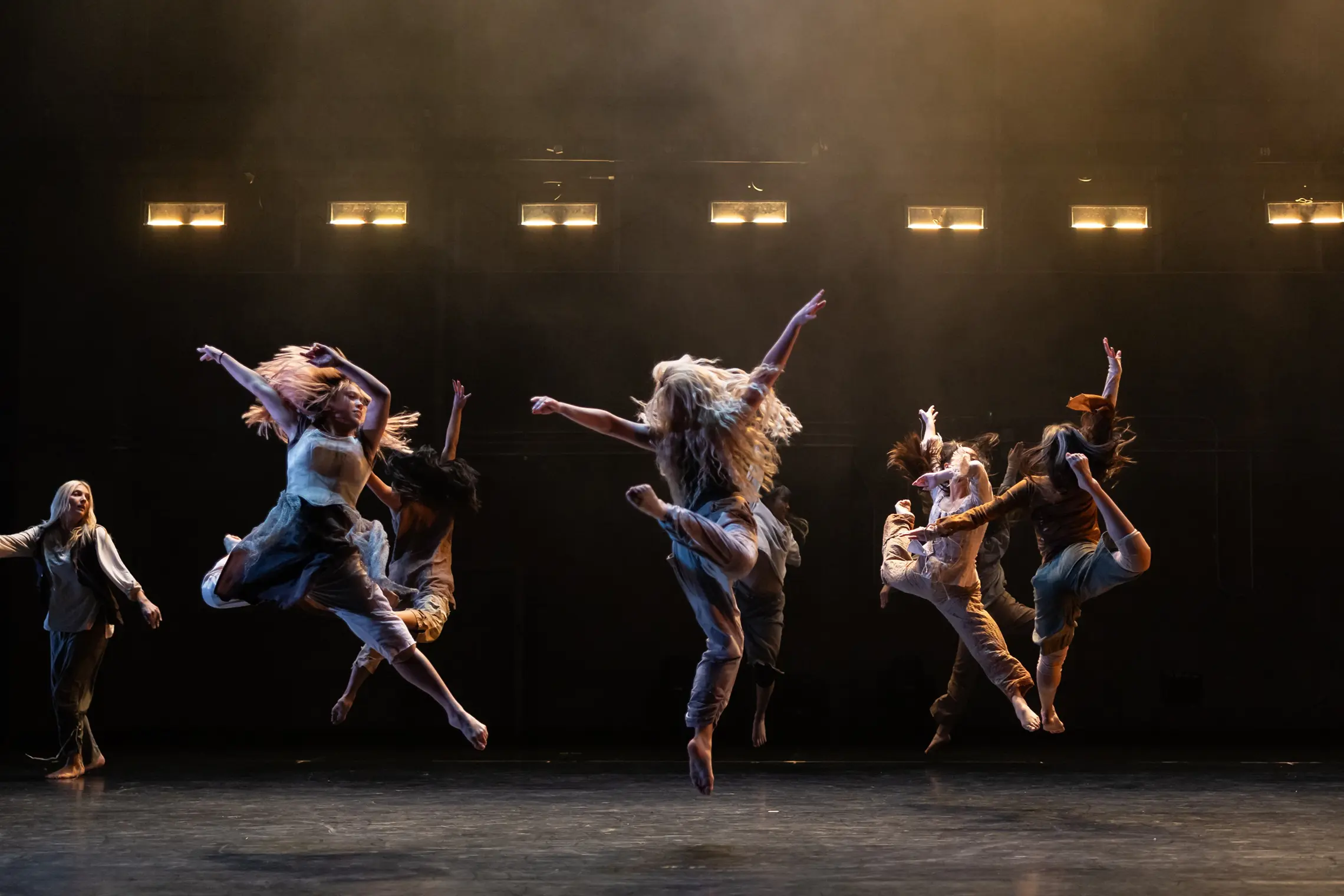 Students jumping in dance performance