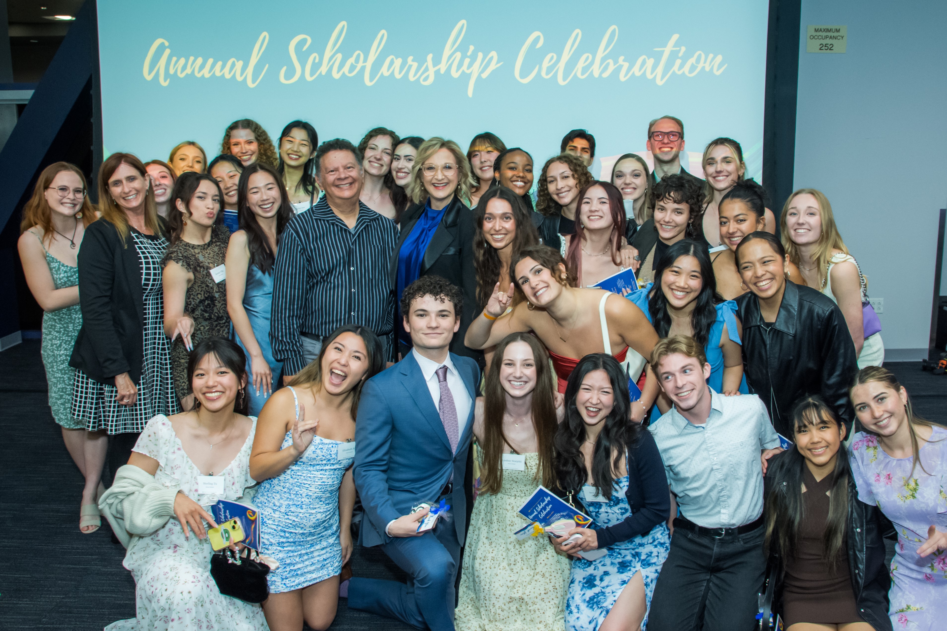 Group photo of smiling students, faculty, and staff gathered at an Annual Scholarship Celebration event.