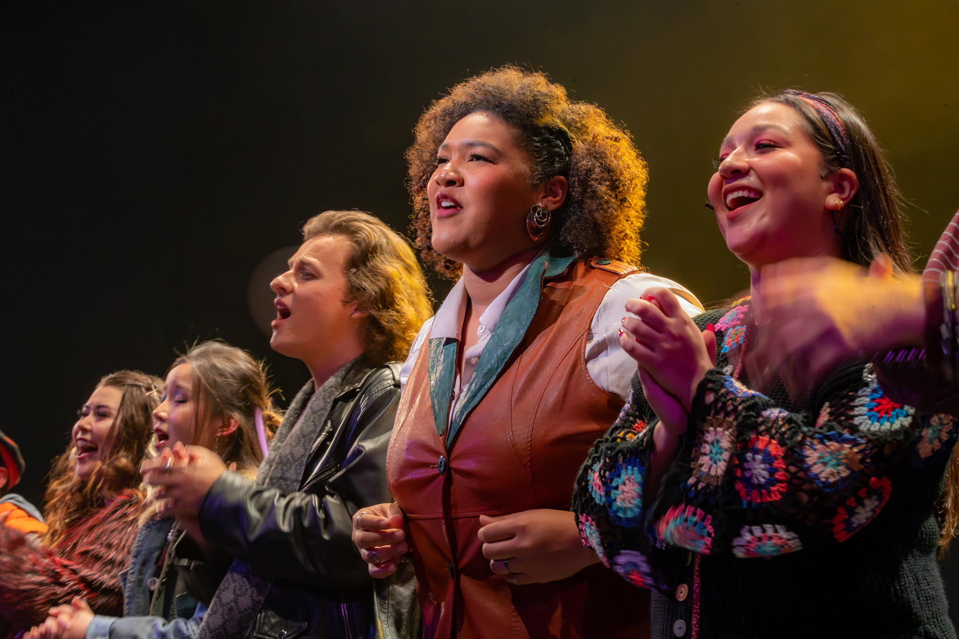 RENT - UCI Drama students perform an ensemble musical number, singing together on stage under theatrical lighting
