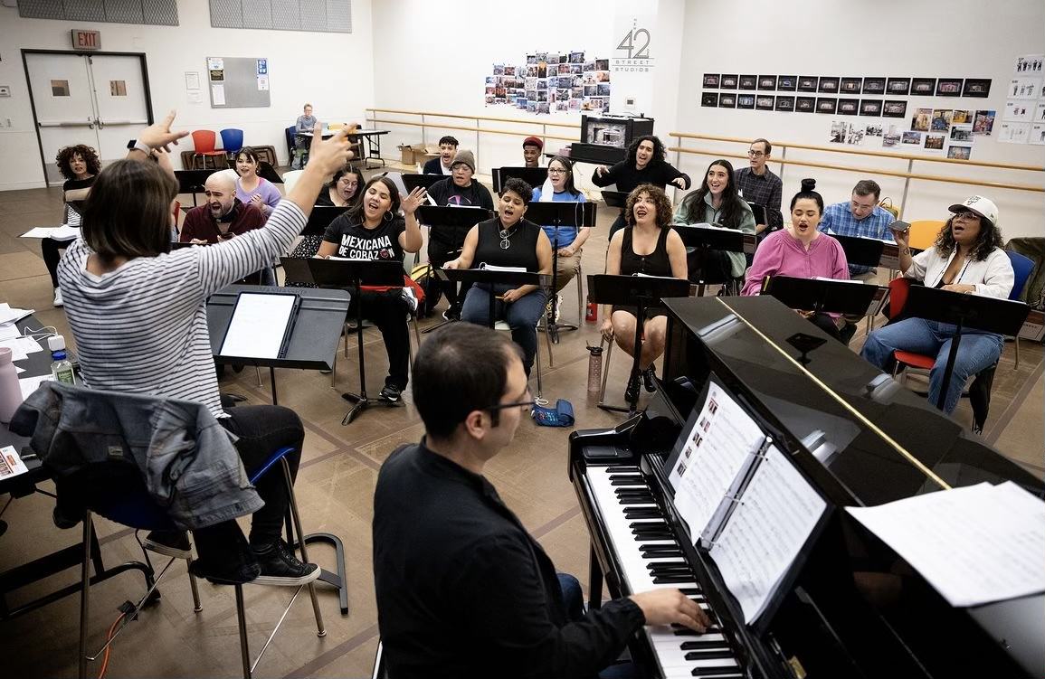  Kayla Quiroz (far left in purple) rhearses with the creative team and cast of Real Women Have Curves: The Musical in the 42nd Street Studios in New York City.