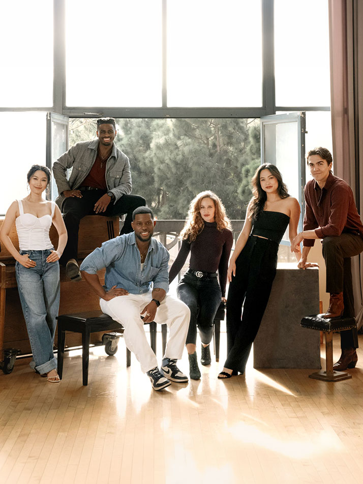 A group of UCI Arts students pose together in a light-filled studio, reflecting a collaborative and interdisciplinary environment
