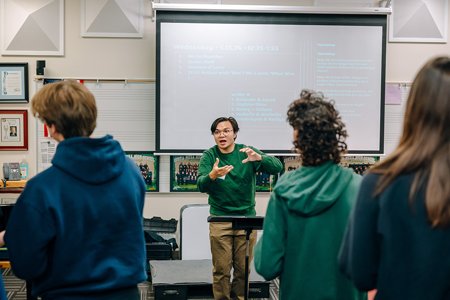 Image: Department of Music student Michael Balerite ’26 conducting in a high school class through Creative Connections. Photo by Will Tee Yang
