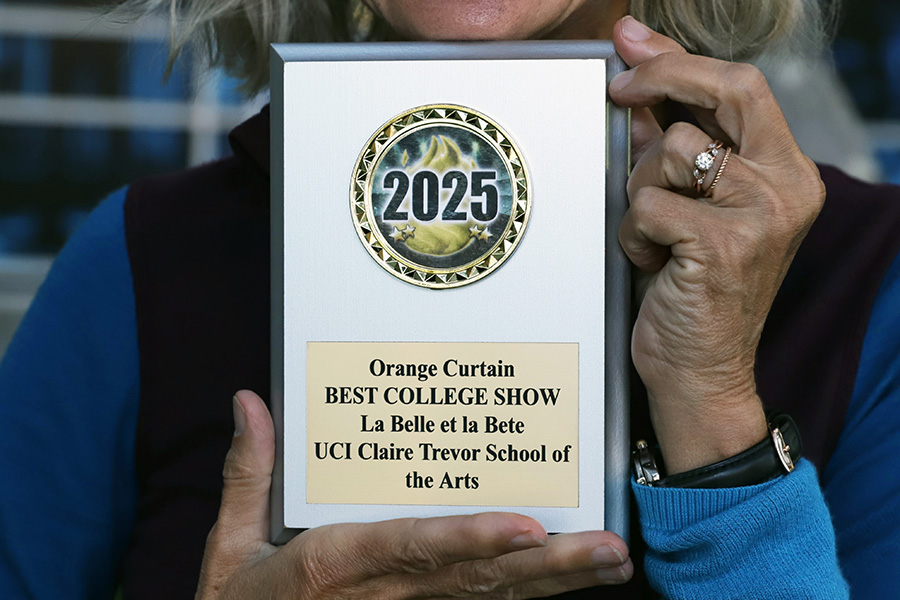 Image: Annie Loui holding the Orange Curtain Review award. Photo by Emily Zheng.