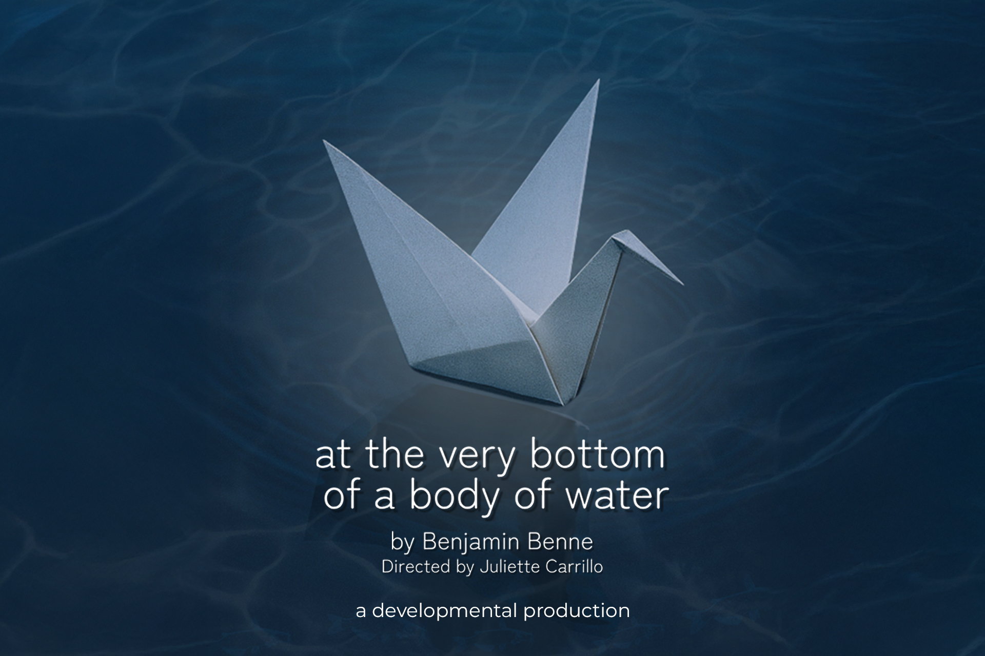 Promotional poster for "at the very bottom of a body of water," a play by Benjamin Benne, directed by Juliette Carrillo. Features a white origami crane against a dark blue underwater background. Labeled "a developmental production."