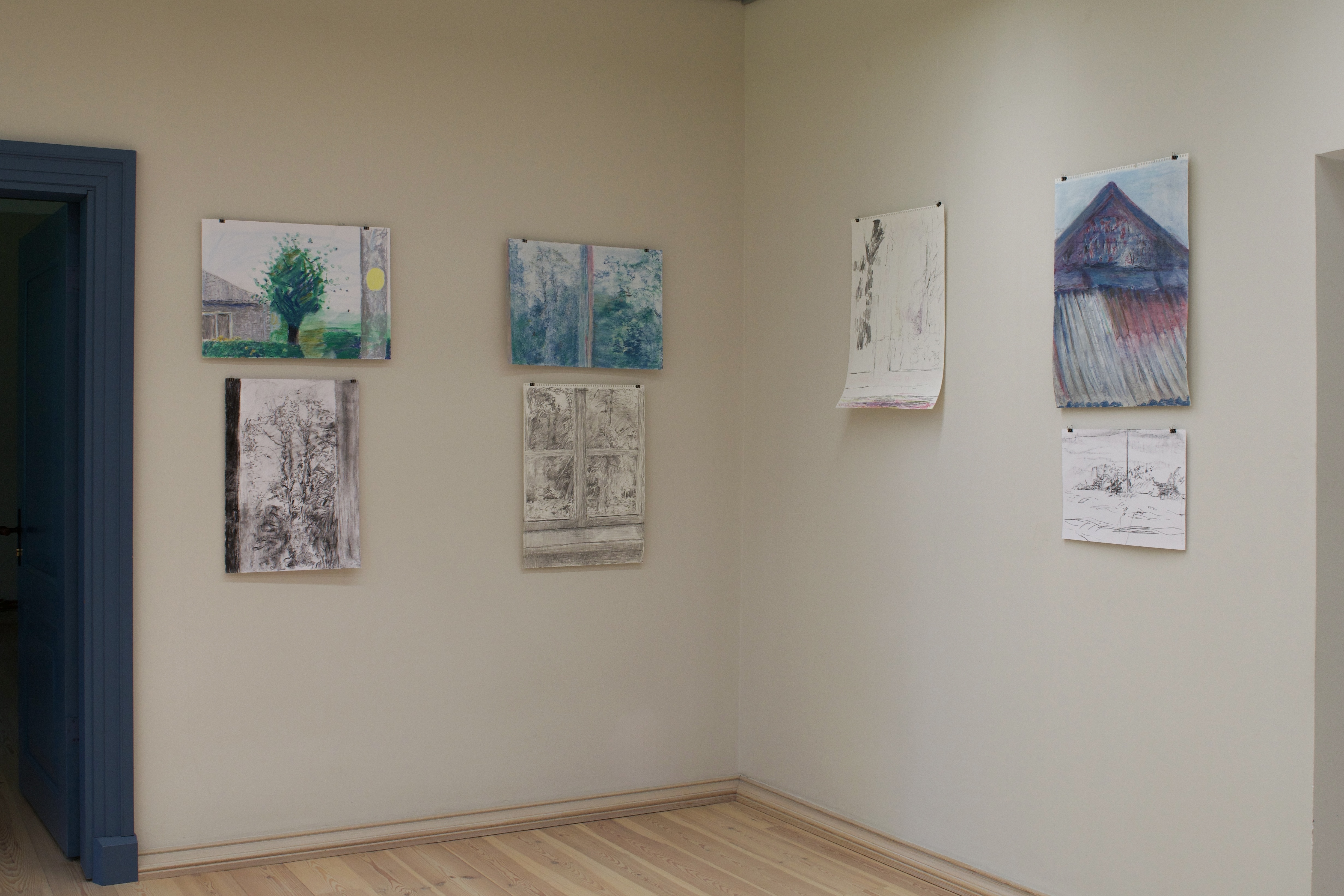 Images hanging on a white wall.