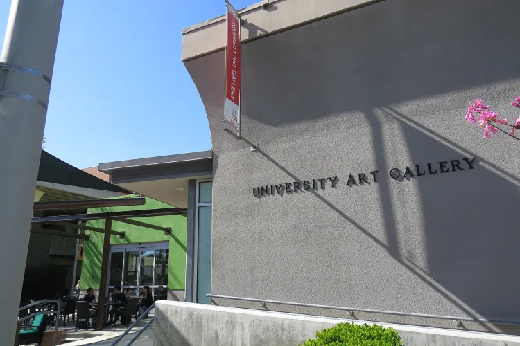 Exterior University Art Gallery, a grey building near a cafe with green walls