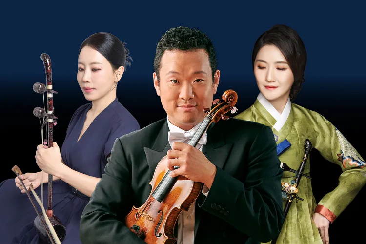 Three musicians pose against a dark blue background, with a man in formal attire holding a violin flanked by two women, one holding a traditional string instrument and one wearing a hanbok.