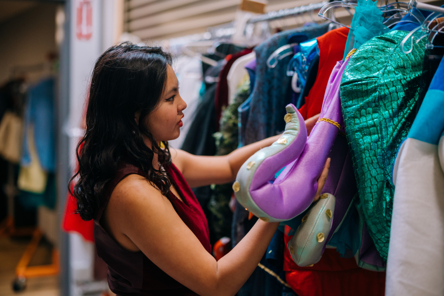 Intern pulling costumes during a work day
