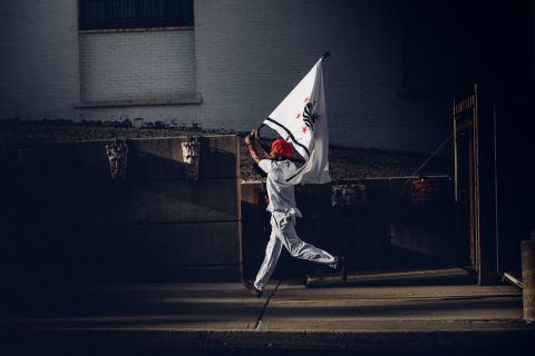 Someone running holding a flag over their head