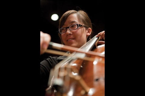 Closeup of someone playing an upright string instrument