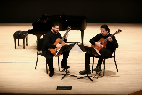 A guitar duo on stage