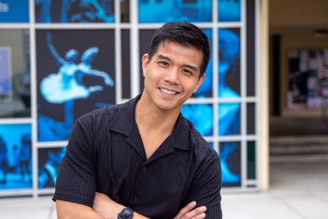 Telly Leung stands in front of the Claire Trevor School of the Arts box office. 