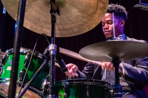 Student musician behind drum set