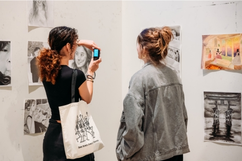 Patron taking picture of art in gallery