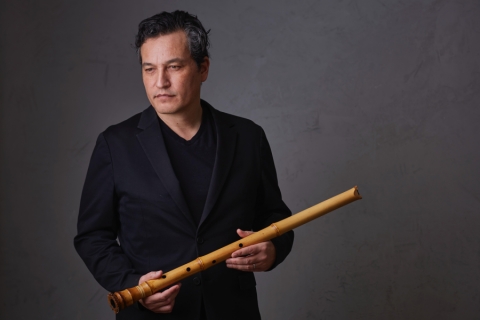 Kojiro Umezaki stands with his instrument the shakuhachi