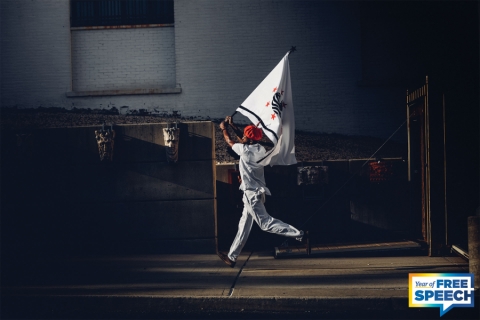 Someone running holding a flag over their head