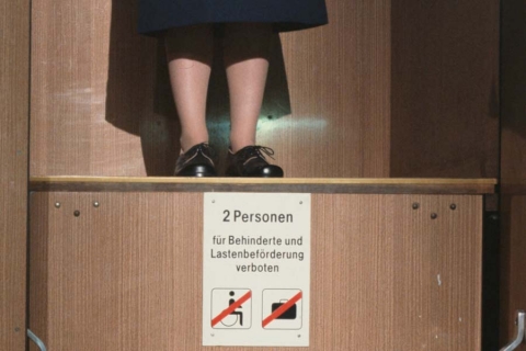 The legs of someone standing on a small platform