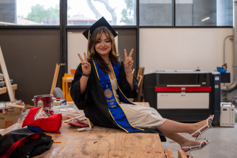 Person in Regalia on wood shop table