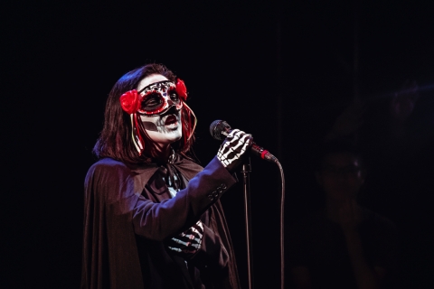 Person in Dia De Los Muertos skull makeup.